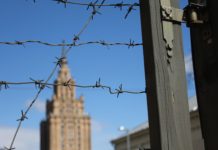Barbed wire fence and buildings