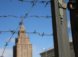Barbed wire fence and buildings