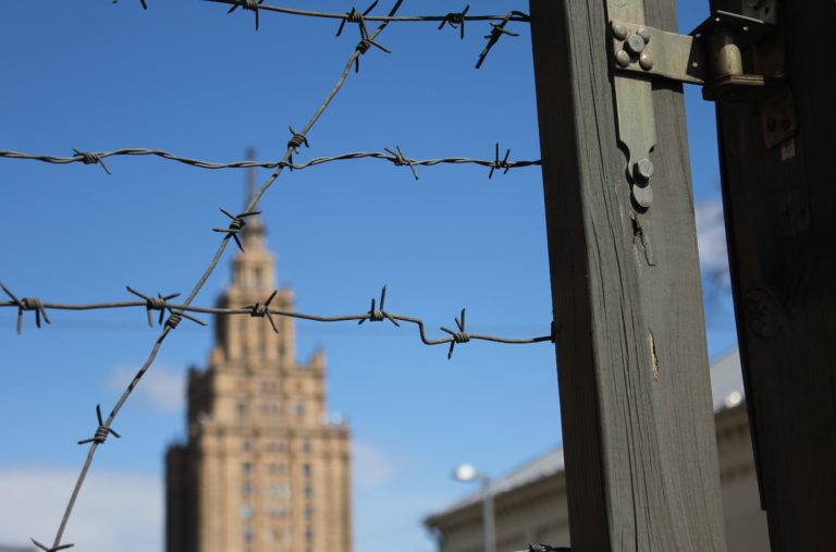 Barbed wire fence and buildings