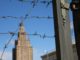 Barbed wire fence and buildings