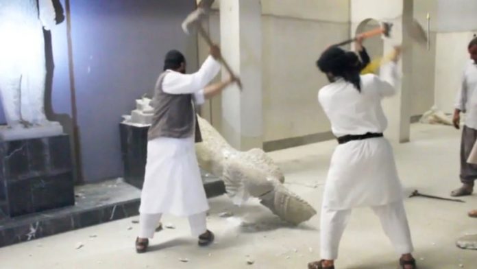 Figure 1. Screenshot of disseminated, reposted, and viral YouTube video of ISIL militants destroy two statues of kings from the ancient city of Hatra in the Mosul Museum.